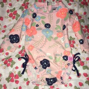 Pink one piece swim suit with floral designs